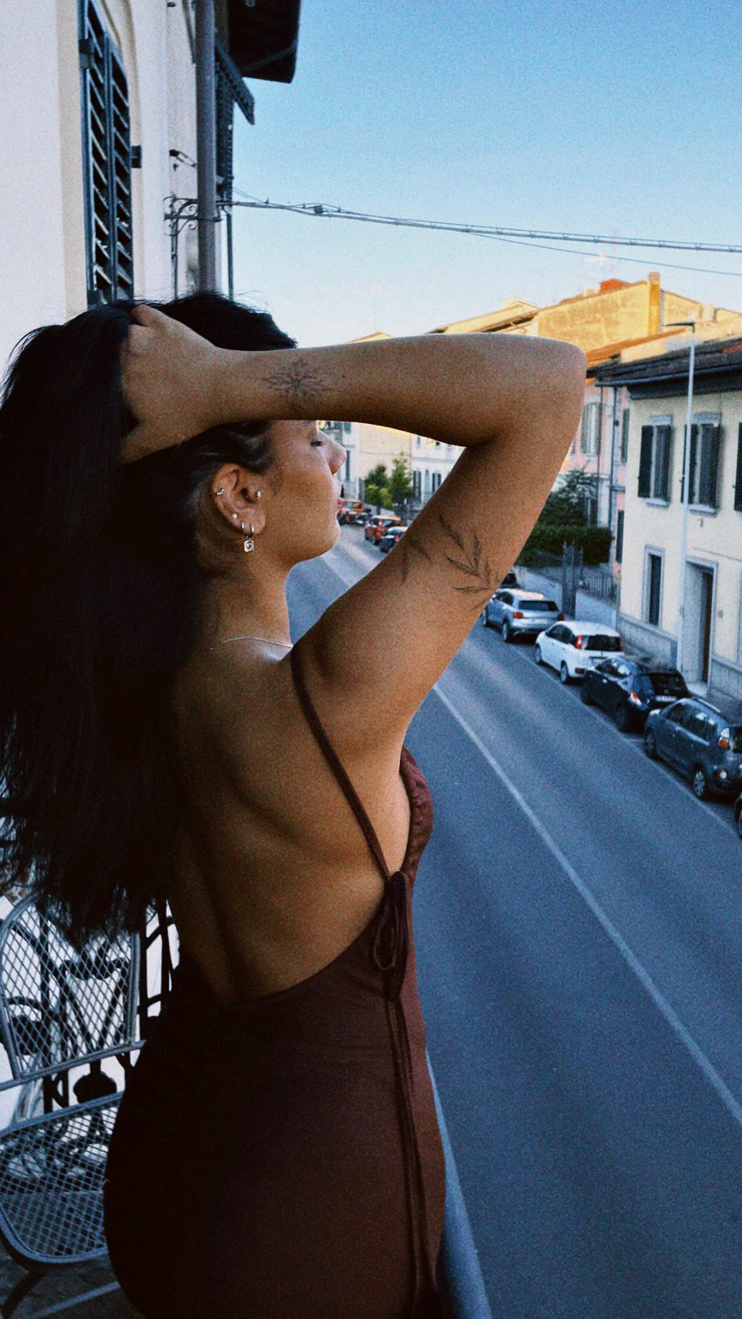 Botanical fine line tattoos on the arm at golden hour