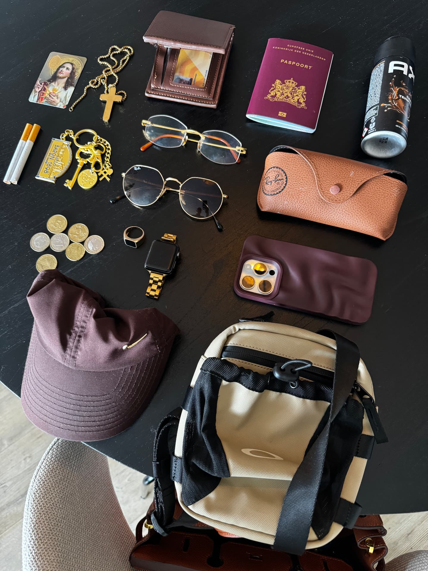 Flatlay of personal objects: jewellery, passport, sunglasses and a cap